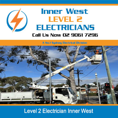 Utility truck with boom working on power lines in Inner West